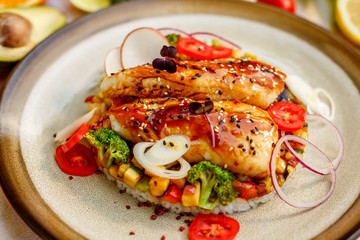 Fish fillet with sesame rice, and vegetables, healthy food on a decorated table