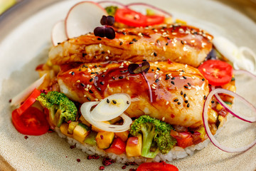 Fish fillet with sesame rice, and vegetables, healthy food on a decorated table
