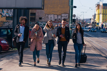 Group of friends (colleagues) hanging out in an urban area.