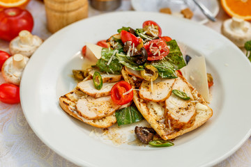 panini with chicken and vegetables on a plate on a decorated table