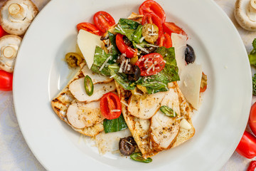 panini with chicken and vegetables on a plate on a decorated table