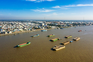 Aerial view of boats carrying sands on the river in My Tho, Tien Giang, Vietnam. Exploiting sands on the Mekong River is making damages the environment. Near Ben Tre