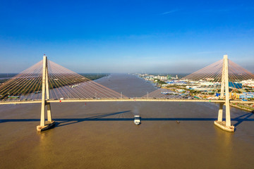 Aerial view of Rach Mieu Bridge, cable-stayed bridge connecting the provinces of Tien Giang and Ben Tre, Vietnam. Famous beautiful bridge of Mekong Delta.  