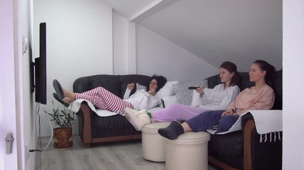 Parents and children all watch movie on tv in pajamas during corona covid 19 quarantine. Social distancing prevention from virus spread - Powered by Adobe