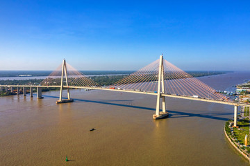 Aerial view of Rach Mieu Bridge, cable-stayed bridge connecting the provinces of Tien Giang and Ben Tre, Vietnam. Famous beautiful bridge of Mekong Delta.  