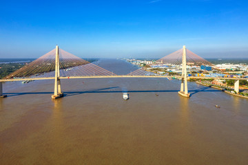 Fototapeta na wymiar Aerial view of Rach Mieu Bridge, cable-stayed bridge connecting the provinces of Tien Giang and Ben Tre, Vietnam. Famous beautiful bridge of Mekong Delta. 