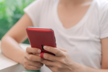 Woman hand use smartphone to do work business, social network, communication in public.