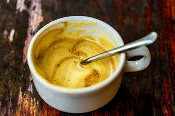Top view a cup of Giang egg coffee  on wood background. Vietnamese coffee in Ha Noi, Vietnam. Eggs are beaten with coffee, hot drink or with ice