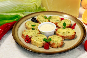 garlic bread with cheese and herbs on a white decorated table