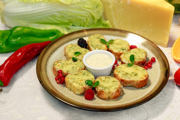 garlic bread with cheese and herbs on a white decorated table