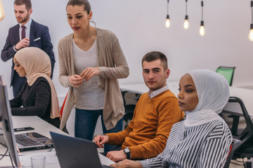 Young business colleagues working together on a computer in a comfortable office atmosphere.