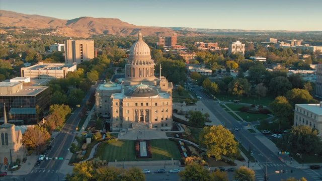 Aerial flying over Idaho State Capitol Building and downtown Boise at sunset. Boise, Idaho, USA. 5 October 2019