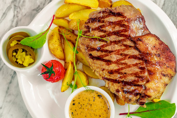beef steak with vegetables, jalapeno sauce and pepper