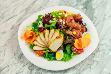 salad with avocado, chicken breast and vegetables