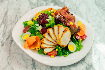salad with avocado, chicken breast and vegetables