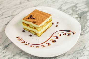 chocolate cheesecake with coffee beans on a white plate