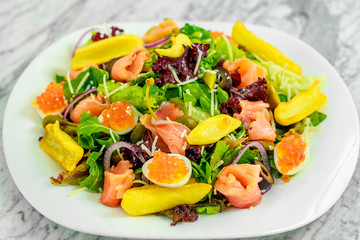 salad with arugula, fish and caviar. Healthy food