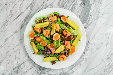 salad with arugula, fish and caviar. Healthy food
