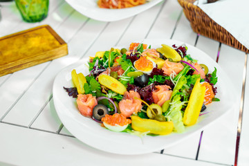 salad with arugula, fish and caviar. Healthy food