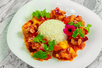 chicken slices in spicy sauce with bell pepper and rice. Beautiful pitch