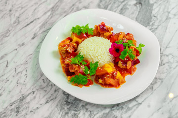 chicken slices in spicy sauce with bell pepper and rice. Beautiful pitch
