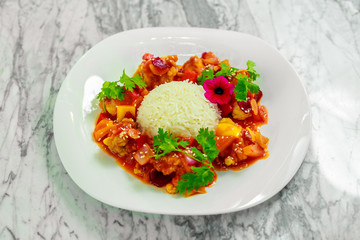 chicken slices in spicy sauce with bell pepper and rice. Beautiful pitch