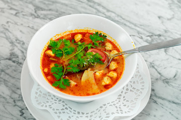 soup with chicken, mushrooms and herbs on a white plate, a beautiful serving