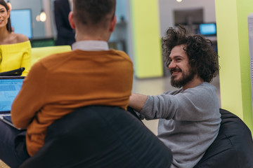 Multiethnic group of employees working in a google environment company. Group of colleagues working on a project in modern offices