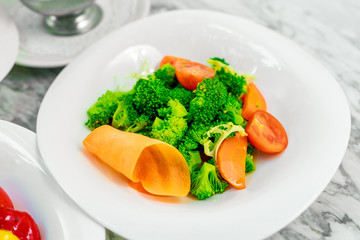 side dishes for the main course,fresh vegetables tomatoes and broccoli, beautiful serving