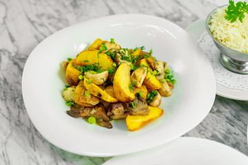 side dishes for the main course,fried potatoes with mushrooms, beautiful serving