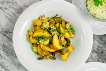 side dishes for the main course,fried potatoes with mushrooms, beautiful serving