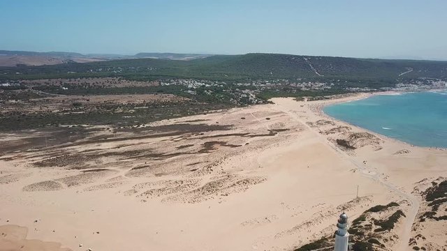 Aerial view of Cape Trafalgar lighthouse,  Cadiz, south-west of Spain. Atlantic Ocean, northwest of the Strait of Gibraltar. In 1805 naval Battle of Trafalgar took place here. Back dolly video