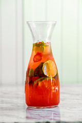 freshly squeezed fresh lemonade with fruit on a light background