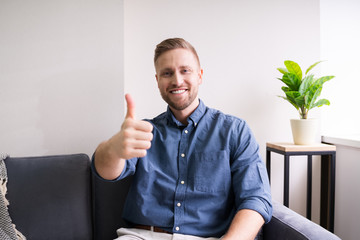 Portrait Of A Happy Young Man Showing Thumbs Up