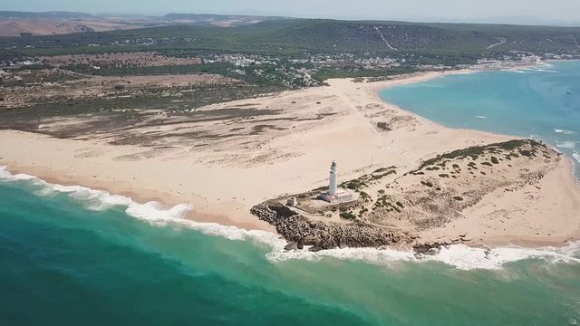 Aerial view of Cape Trafalgar lighthouse,  Cadiz, south-west of Spain. Atlantic Ocean, northwest of the Strait of Gibraltar. In 1805 naval Battle of Trafalgar took place here. Back dolly video