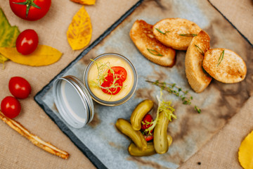 Autumn table setting with pumpkins. Thanksgiving dinner. Pate with breadcrumbs and pickled cucumbers