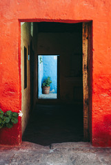 Obraz na płótnie Canvas Door with Orange and Blue Walls in Santa Catalina Monastery, Arequipa, Peru