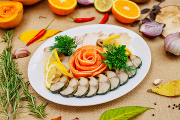 Autumn table setting with pumpkins. Thanksgiving dinner. fish platter with lemon in a white plate