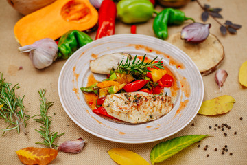 Autumn table setting with pumpkins. Thanksgiving dinner.grilled chicken breast with vegetables