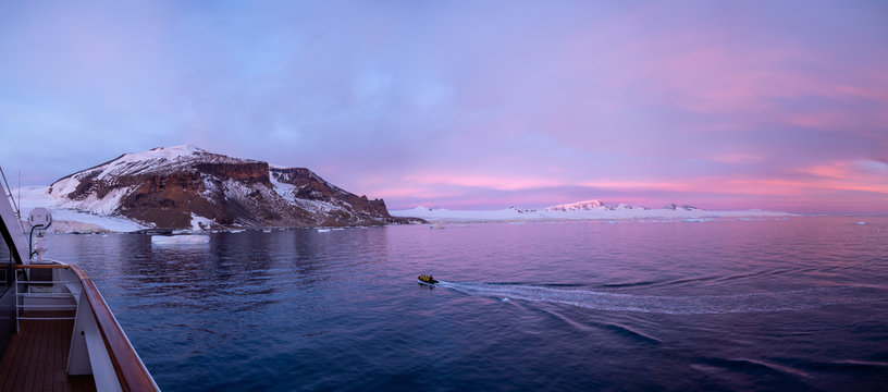 inflatable boat on the water, sunrise, Brown Bluff, Antarctic Peninsula.