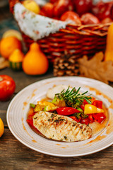 Autumn table setting with pumpkins. Thanksgiving dinner.grilled chicken breast with vegetables
