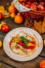 Autumn table setting with pumpkins. Thanksgiving dinner.grilled chicken breast with vegetables