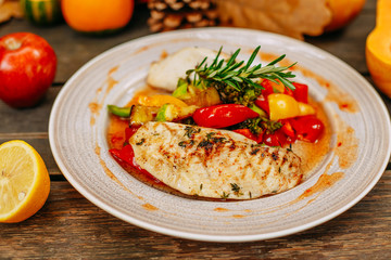 Autumn table setting with pumpkins. Thanksgiving dinner.grilled chicken breast with vegetables