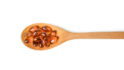 fish oil in wooden spoon isolated include clipping path on white background stack photo