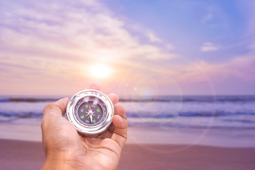 Hand holding Compass for finding direction