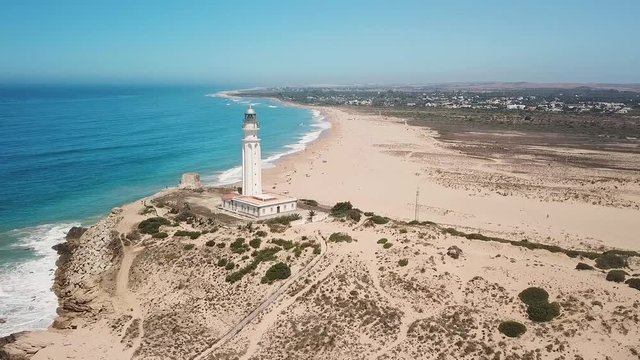 Aerial view of Cape Trafalgar, drone having point of interest the lighthouse,  Cadiz, Spain. Atlantic Ocean, northwest of the Strait of Gibraltar. In 1805 naval Battle of Trafalgar took place here.