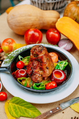 Autumn table setting with pumpkins. Thanksgiving dinner.baked pork shank with vegetables