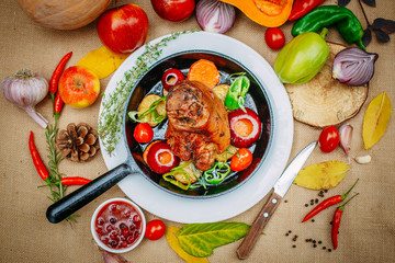 Autumn table setting with pumpkins. Thanksgiving dinner.baked pork shank with vegetables