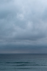 View of sea against cloudy sky during rain