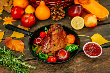 Autumn table setting with pumpkins. Thanksgiving dinner.baked pork shank with vegetables